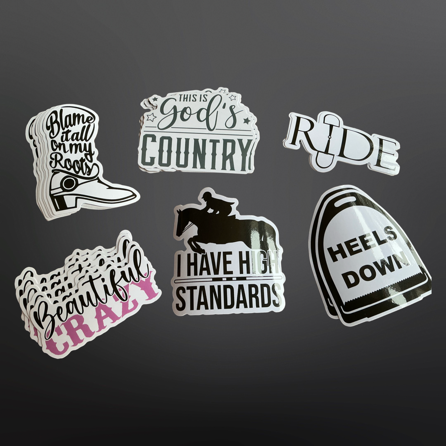 A collection of black PVC stickers with various equestrian-themed phrases and images, including boots, a horse, and riding gear.