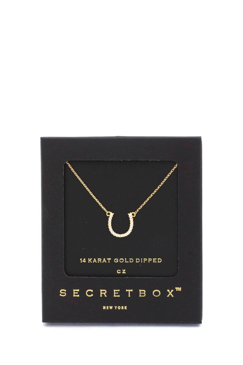 Gold Horseshoe shaped necklace in a SecretBox packaging on a white background