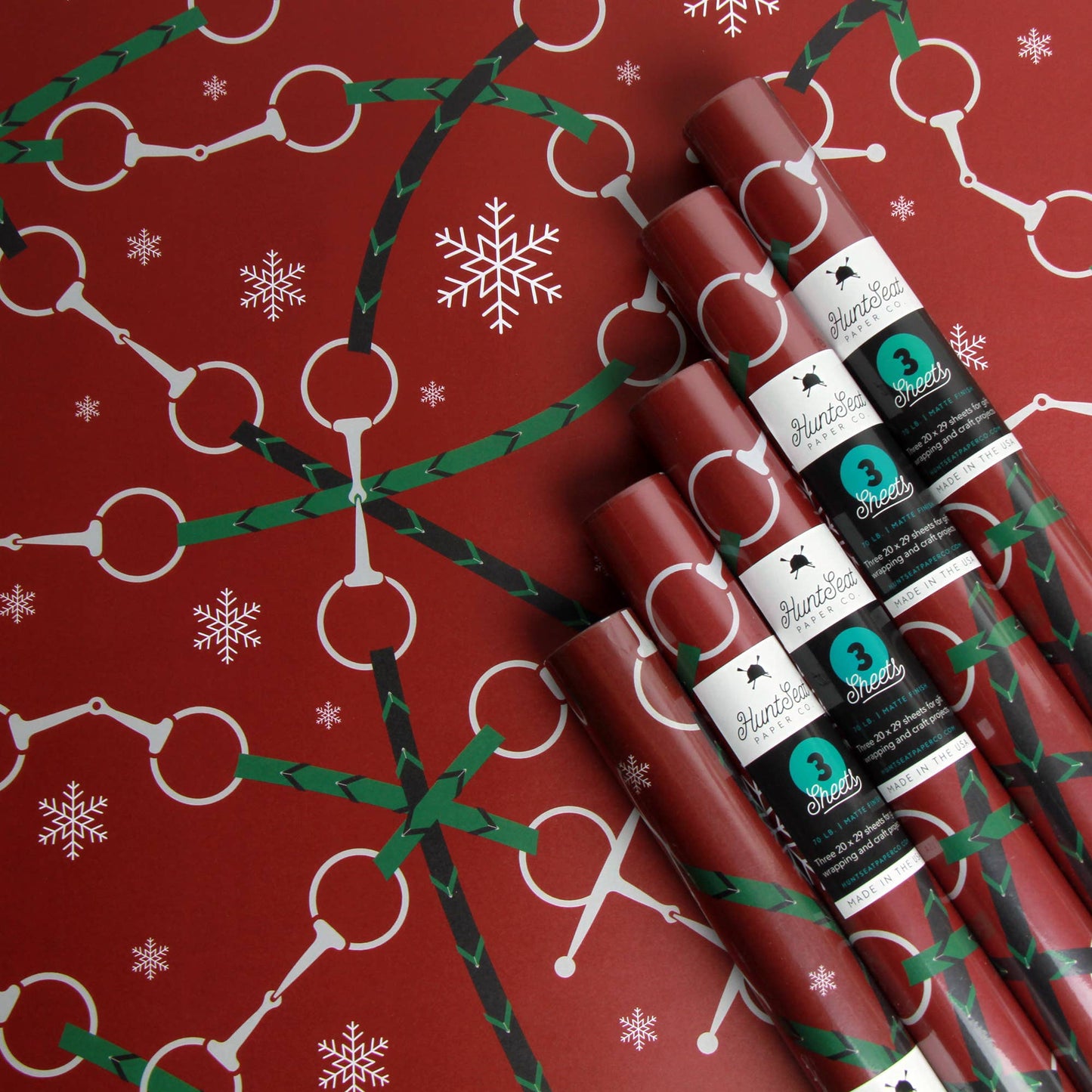 Festive Equestrian Christmas Wrapping paper, red paper with snaffle bit designs and snow flakes