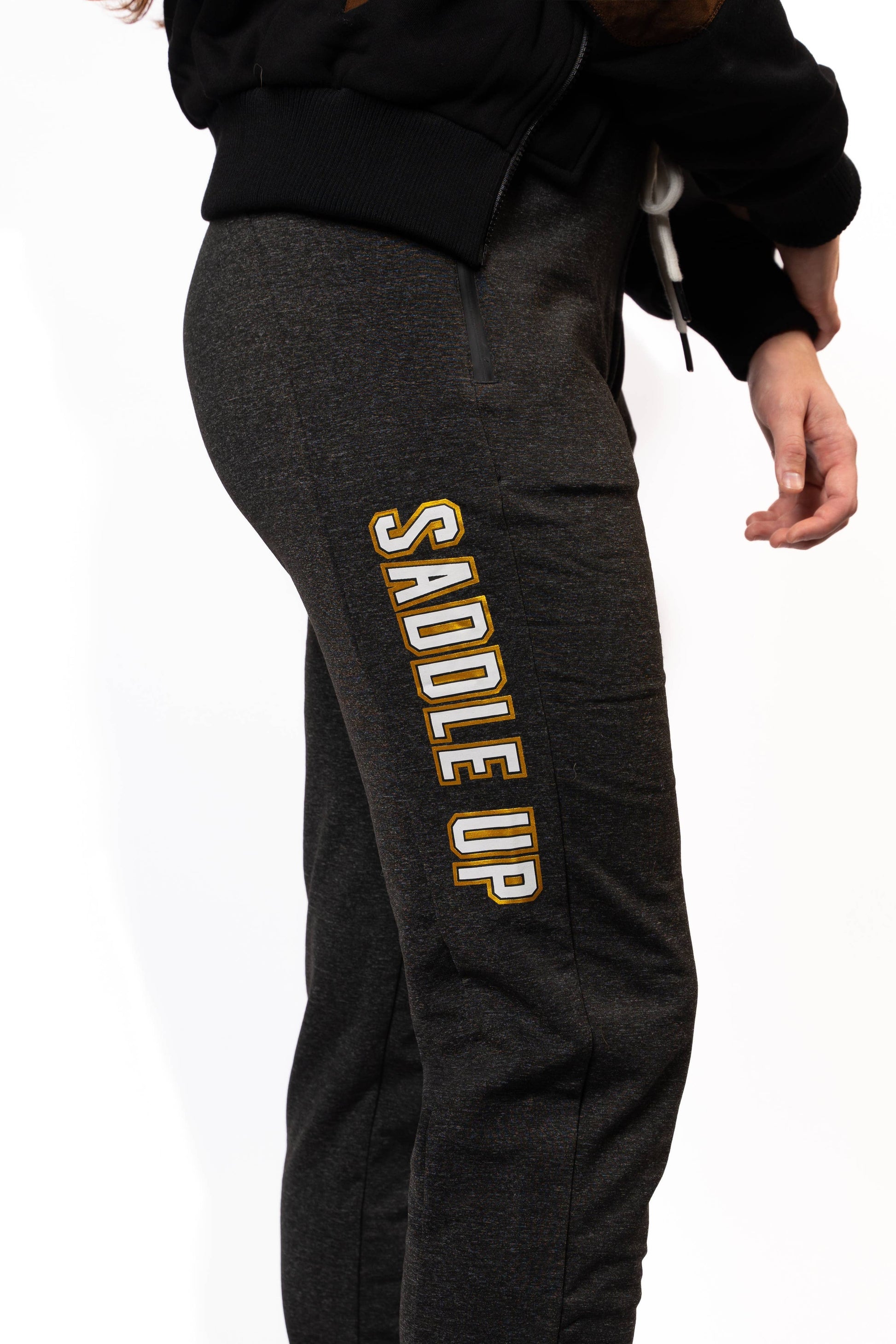 Gray jogger-style sweatpants featuring "Saddle Up" written in white lettering with a gold sparkle outline