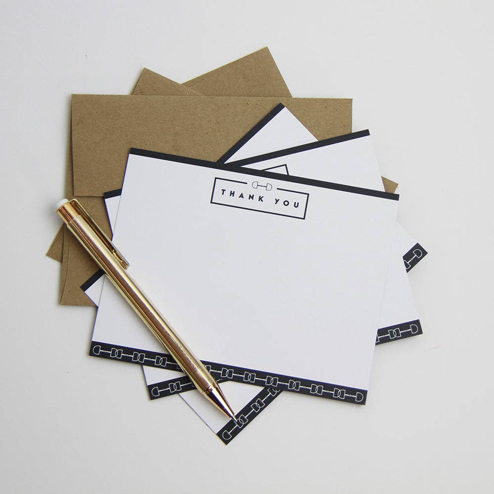 Stack of white cards with 'Thank You' text and gold pen on a light gray background. Equestrian gift set with snaffle bit design