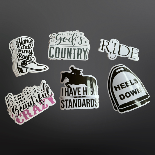 A collection of black PVC stickers with various equestrian-themed phrases and images, including boots, a horse, and riding gear.