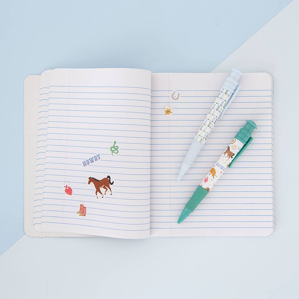 Open notebook with lined pages featuring horse illustrations and a pen on a light blue background