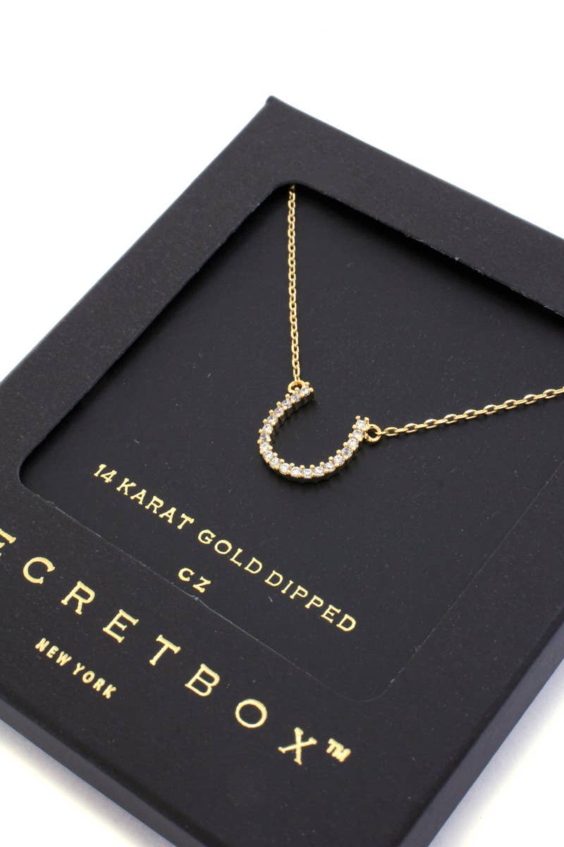 Gold necklace on a Secret Box New York branded card