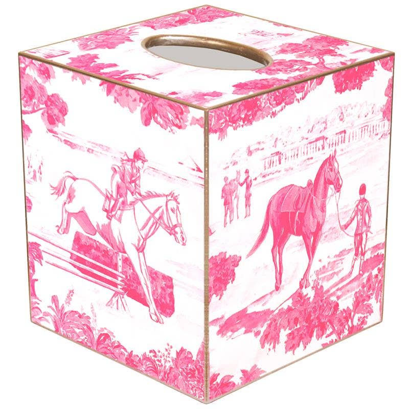 A pink tissue box cover with a toile pattern featuring horses and riders.