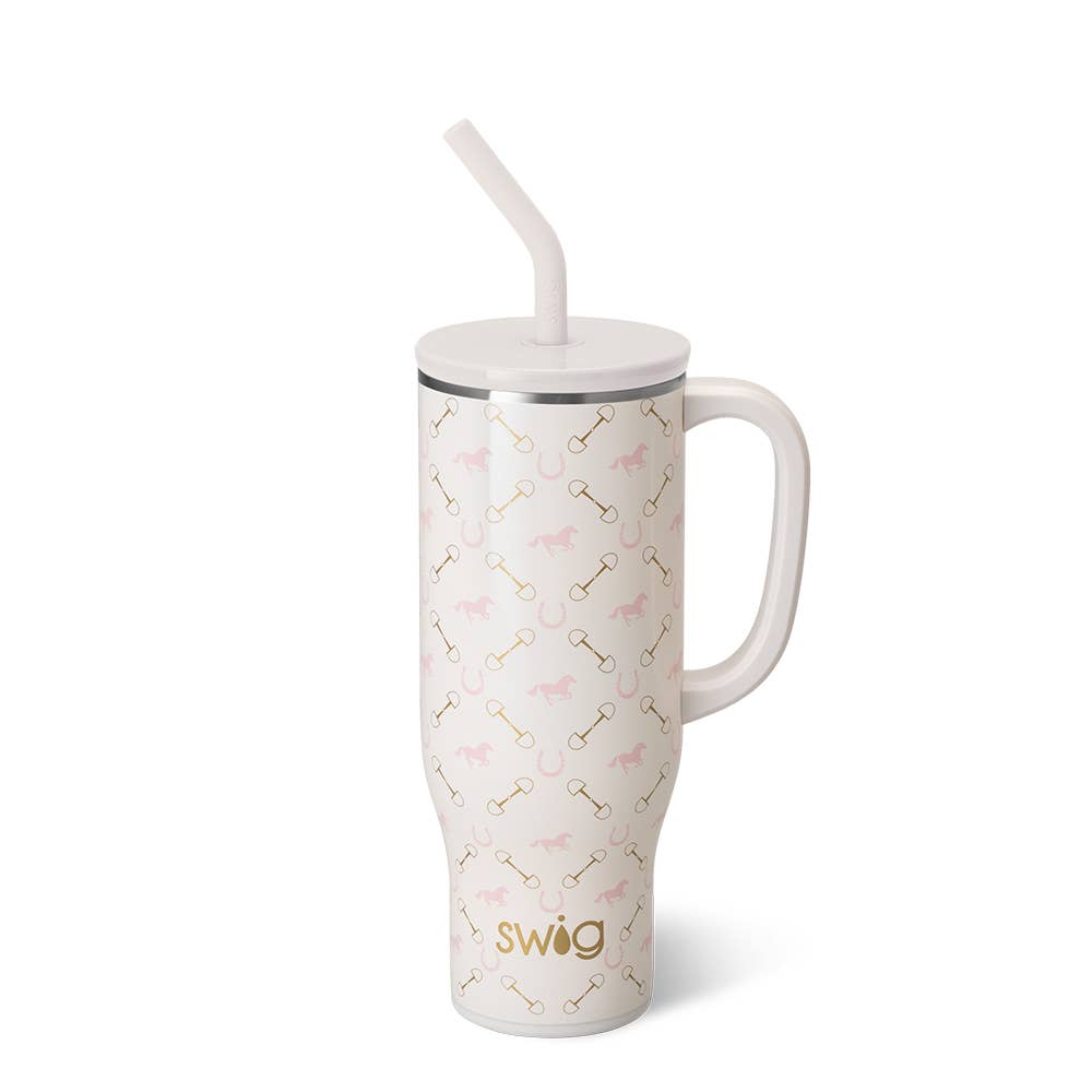 A pink stainless steel mega mug with a pattern of horses and horseshoes, a white plastic straw, and the brand 'swig' visible on the mug.