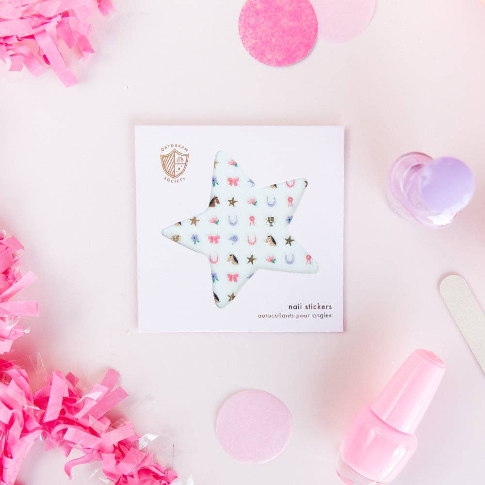 Star-shaped nail sticker sheet on a pink background with decorative items