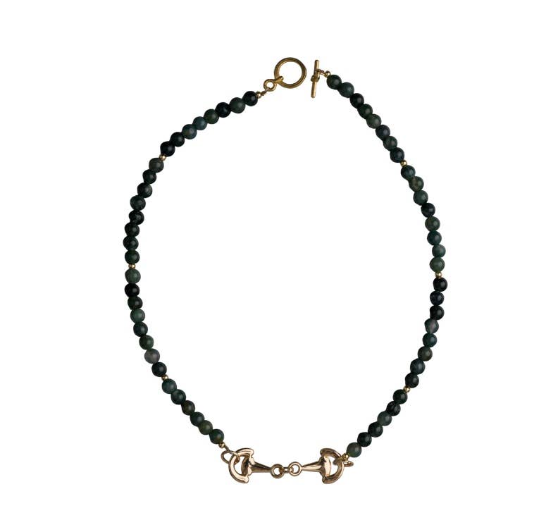 Green beaded necklace with gold horsebit pendant and gold clasp on a white background