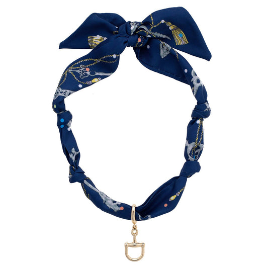 Navy blue scarf necklace with decorative elements and a gold horse bit charm on a white background