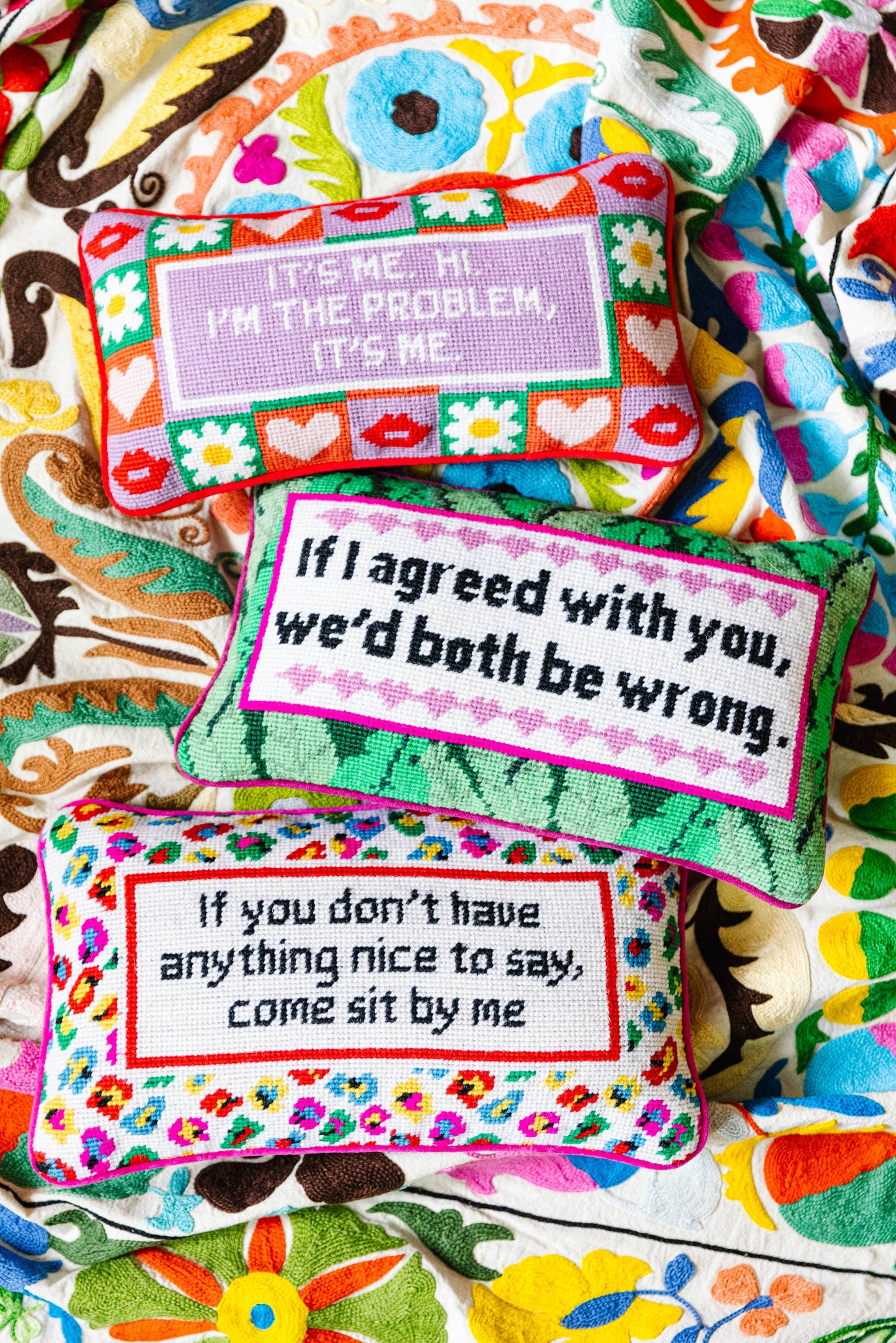 Needlepoint pillows with cleaver sayings on them