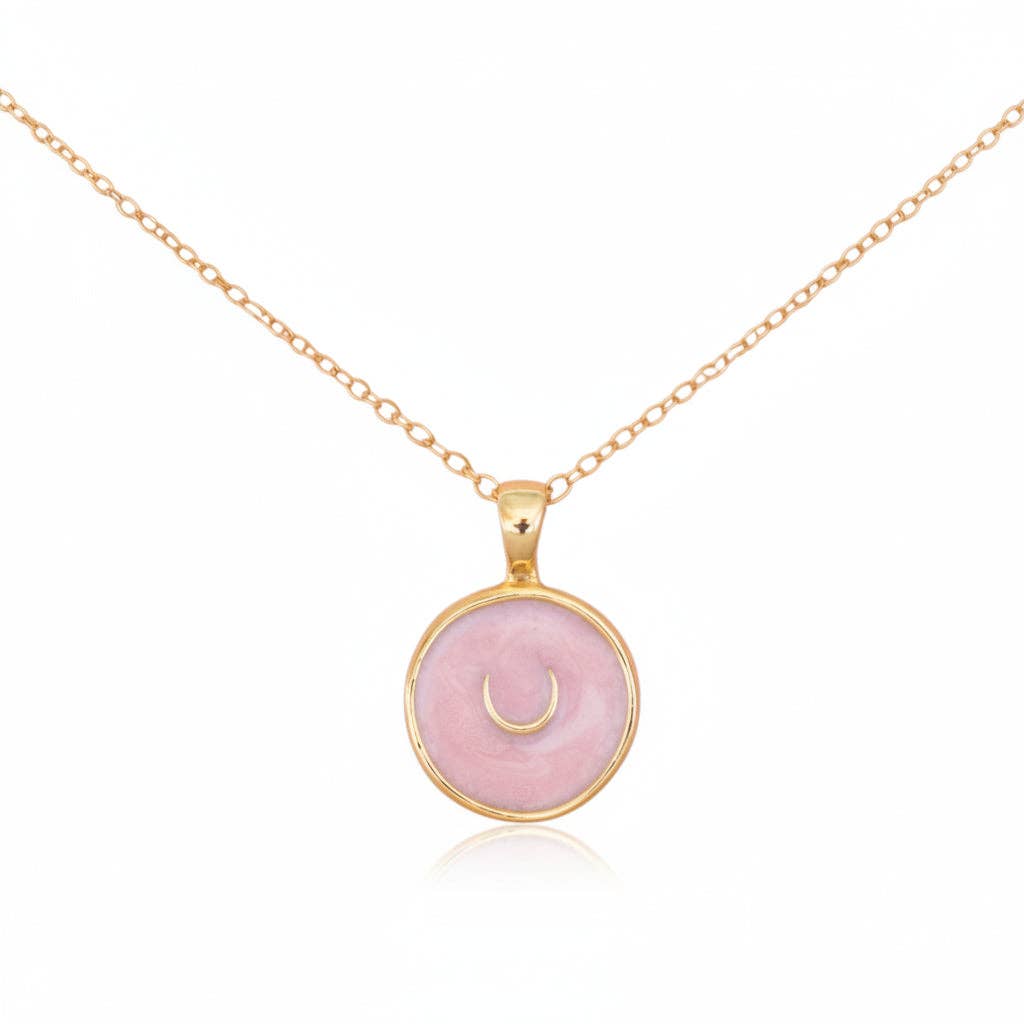 Necklace with a pink pendant and gold chain on a white background