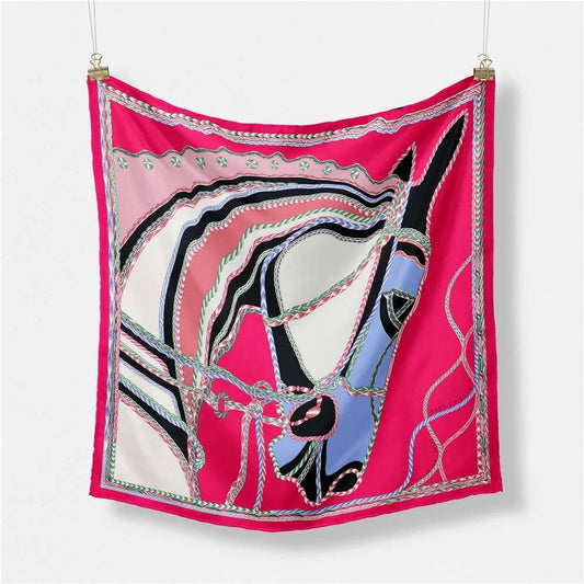 bright pink silk scarf with a beautiful horse head design, on a white back ground, hanging from silver clips