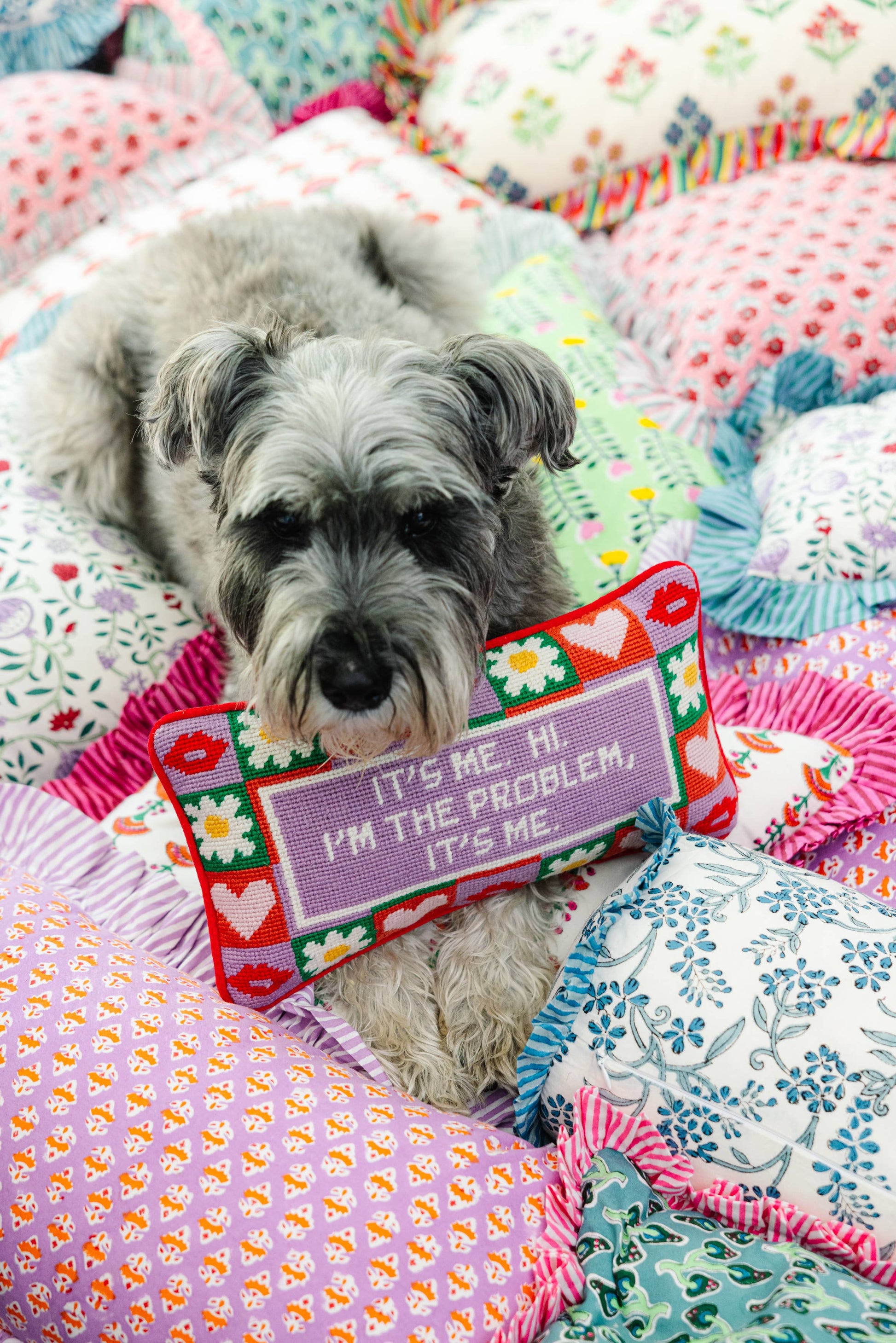needlepoint pillow with saying "it's me. hi. i'm the problem, it's me", backled in pink velvet