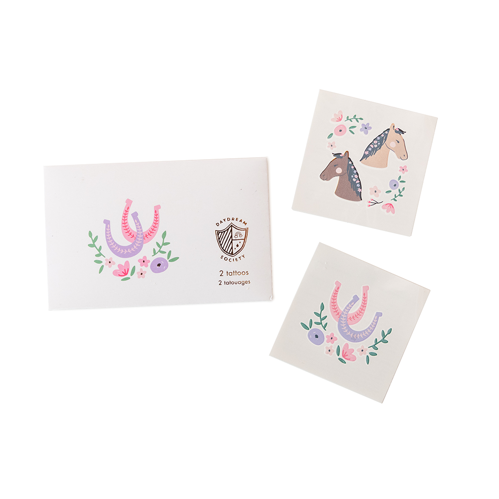 Set of temporary tattoos with horse designs on white cards.