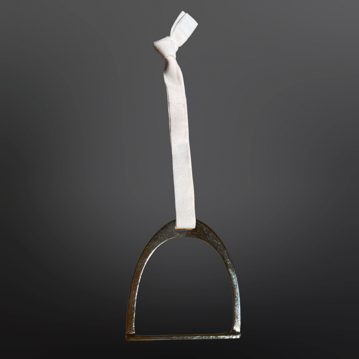 Metal horseshoe with a white bandage on a dark gray background