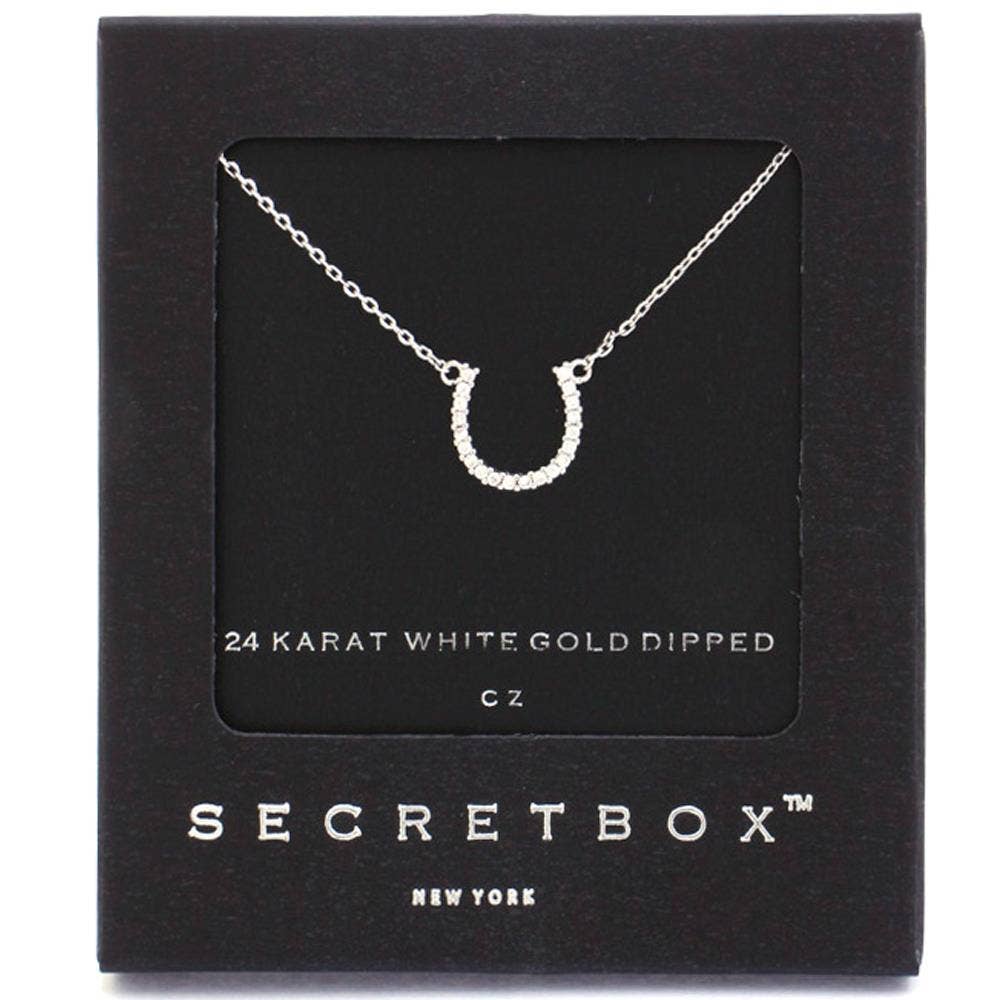 Horseshoe necklace on a Secretbox card with '24 Karat White Gold Dipped' text.