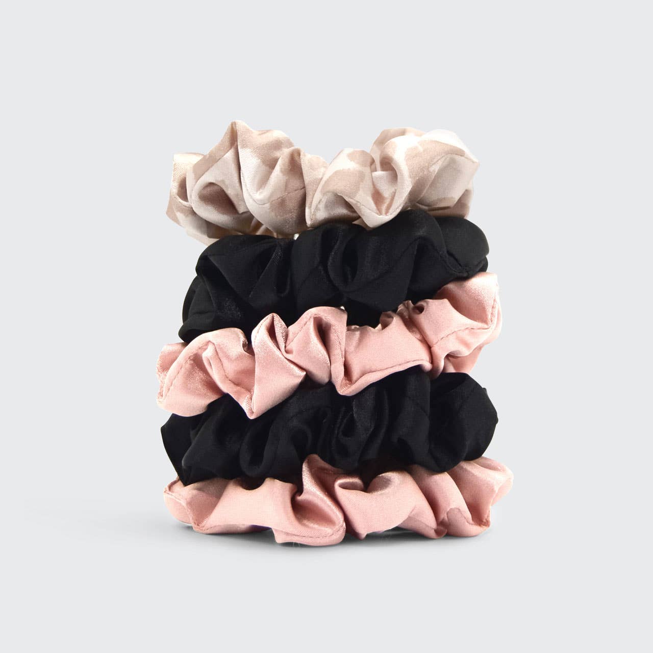 Soft blush pink satin hair scrunchie for equestrian sleep and riding, designed to eliminate hair creases and helmet hair.
