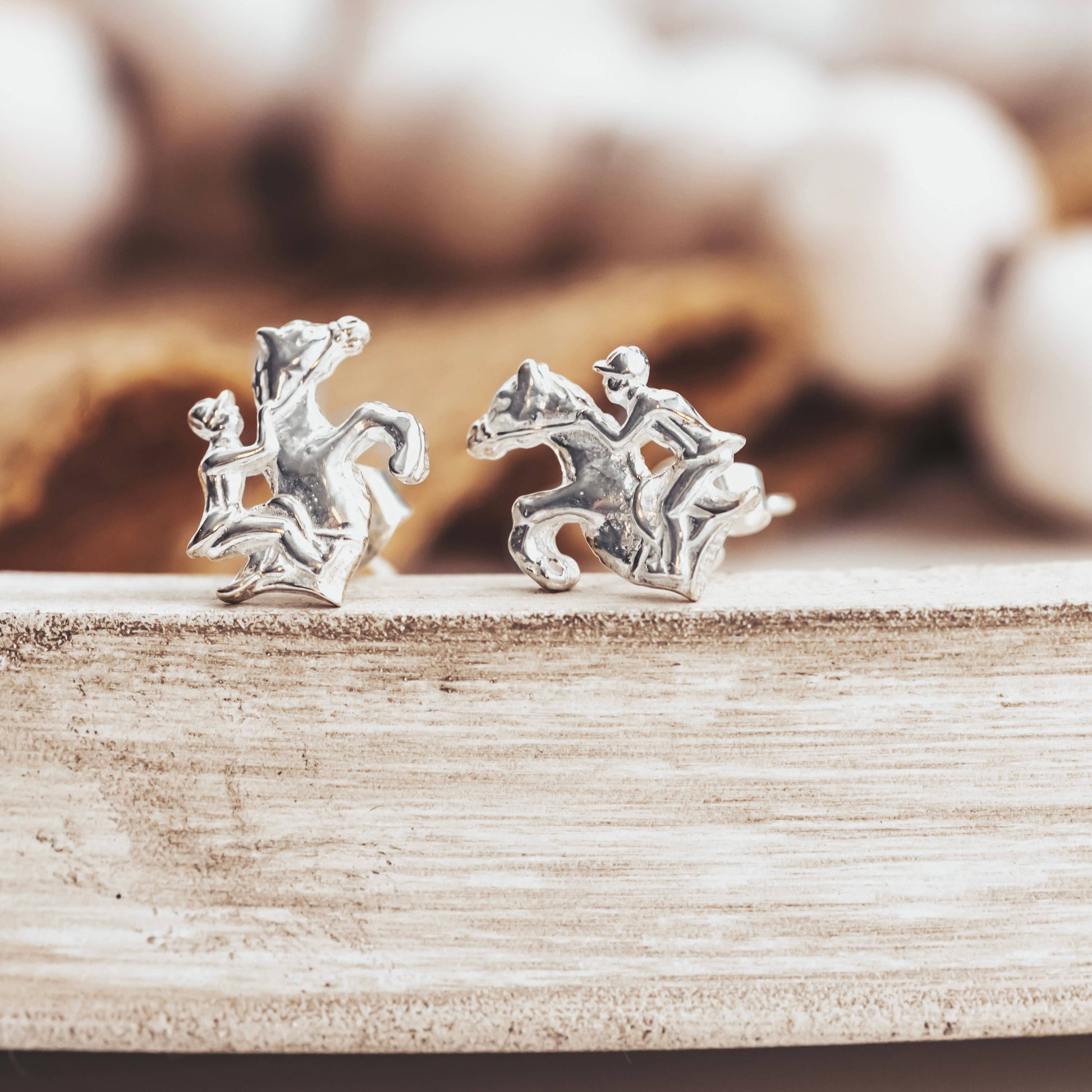 sterling silver earrings of a rider and horse jumping